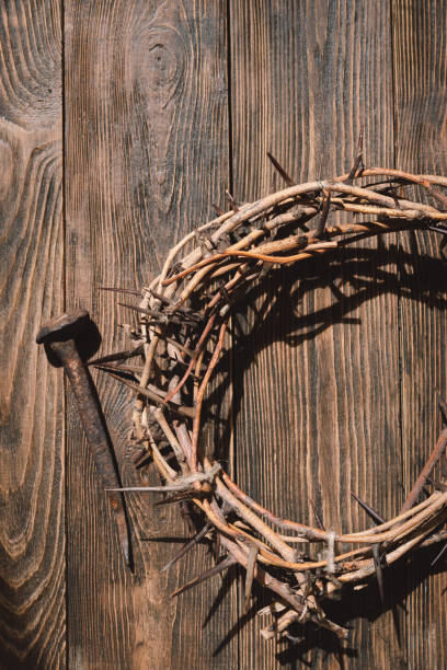 istock Jesus Crown Thorns and nails and cross on a wood background. 2191289794
