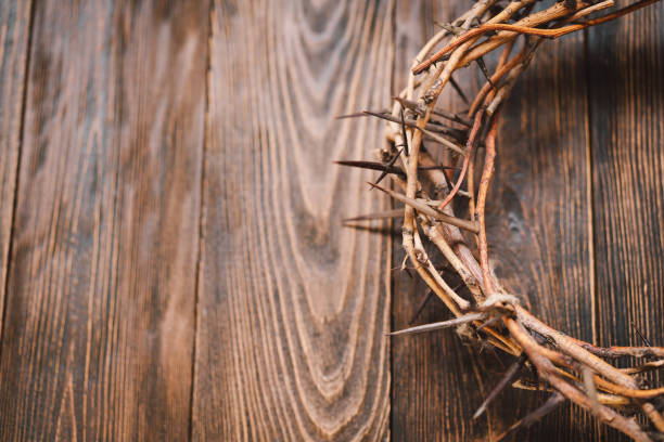 istock Jesus Crown Thorns and nails and cross on a wood background. 2191289813