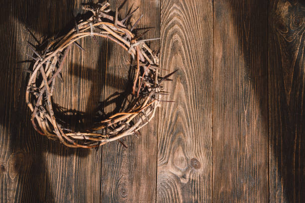 istock Jesus Crown Thorns and nails and cross on a wood background. 2191289816