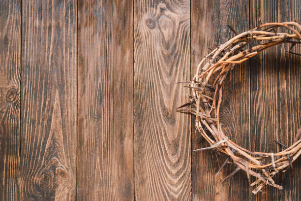 istock Jesus Crown Thorns and nails and cross on a wood background. 2191289821