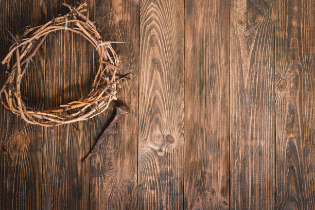 istock Jesus Crown Thorns and nails and cross on a wood background. 2191289835