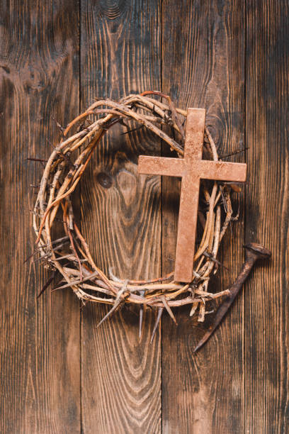 istock Jesus Crown Thorns and nails and cross on a wood background. 2191289892