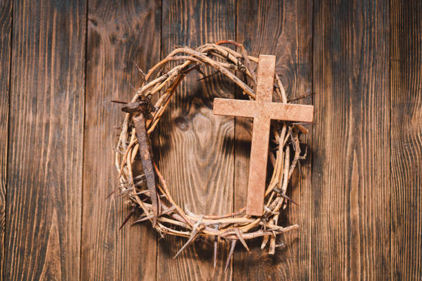 istock Jesus Crown Thorns and nails and cross on a wood background. 2191289906