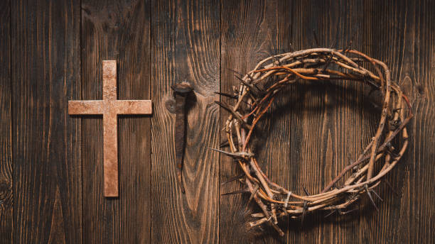 istock Jesus Crown Thorns and nails and cross on a wood background. 2191289908