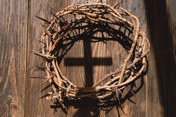 istock Jesus Crown Thorns and nails and cross on a wood background. 2191289952