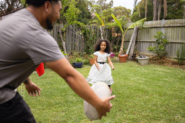 istock Pacific Islander brother and sister playing rugby in their back yard 2191292754