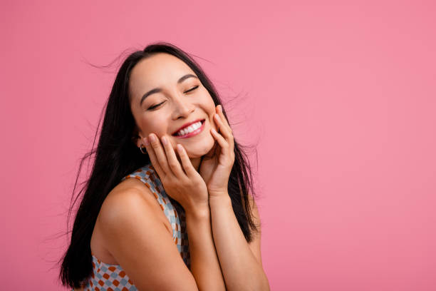 istock Joyful young woman with charming smile posing against a pink background 2191293719