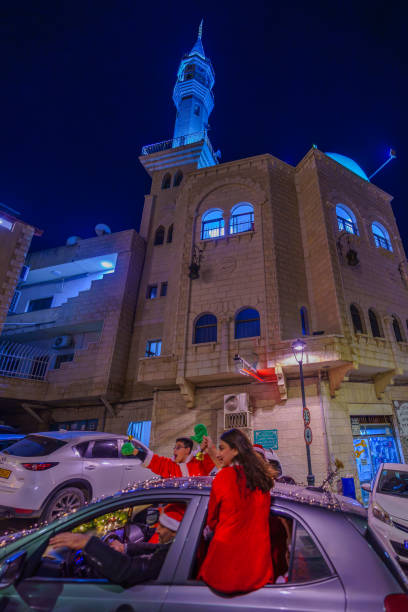 Shefa-Amr, Israel - December 19, 2024: View of people celebrating Christmas, and the Old Mosque in the background. Shefa-Amr (Shfaram), Israel