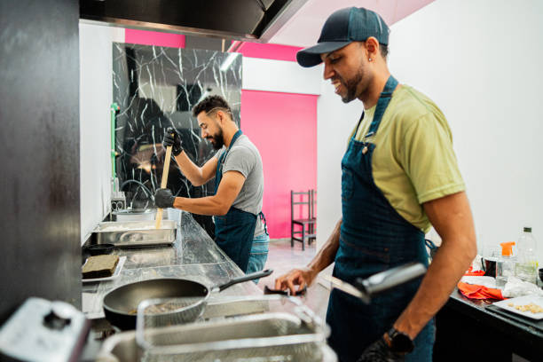 istock Mid adult man cooking on sushi bar kitchen 2191294496