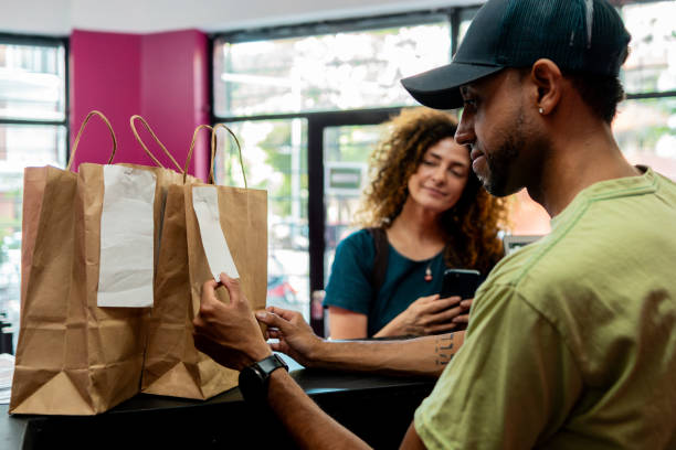 Cashier looking food bag at restaurant