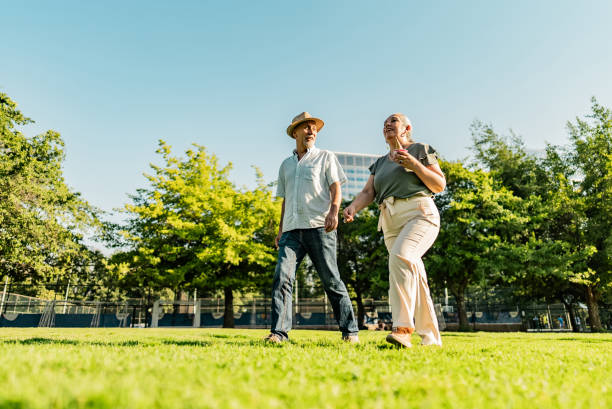Senior couple talking and walking in a public park