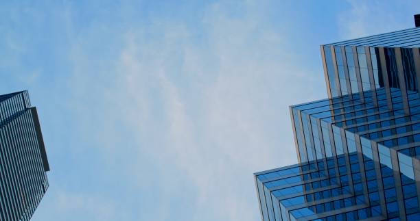istock Contemporary skyscrapers tower against clear blue sky, impressive innovative architecture. Captivating view of modern skyscrapers against blue sky, urban architecture's elegance and scale. 2191296599