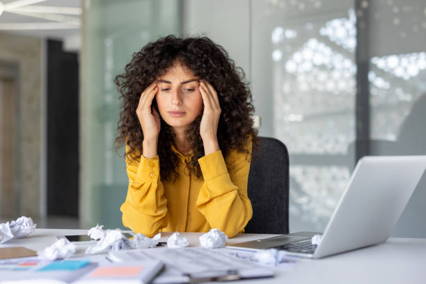istock Stressed businesswoman overwhelmed by paperwork in modern office environment 2191297343
