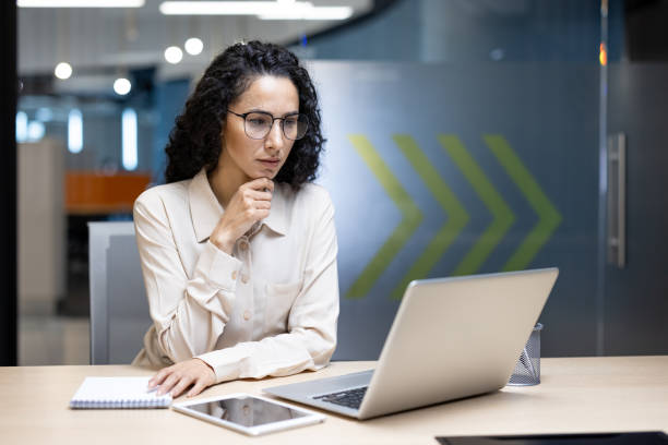 istock Focused businesswoman working on a laptop in a modern office setting 2191298773