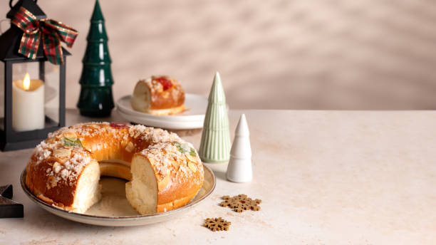 istock Spanish Three kings cake on decorated table with Christmas tree and burning candles, celebration of Three Kings Day 2191299157