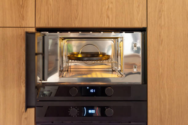 istock Black built-in microwave with open door in wooden kitchen 2191300102