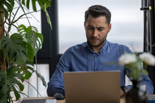 istock Focused businessman working on laptop in modern office 2191300386