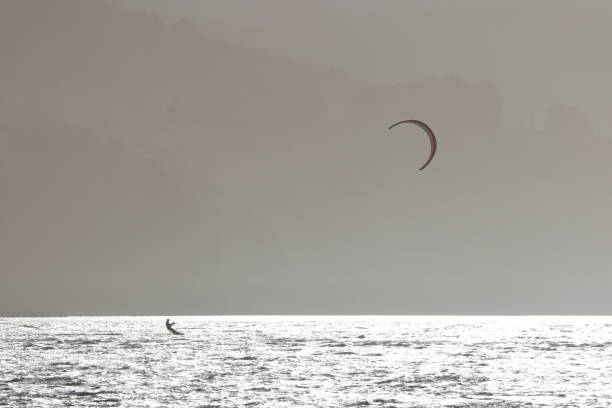 Surfer practicing kitesurfing in the Urdaibai estuary. Basque Country.
