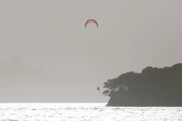 Surfer practicing kitesurfing in the Urdaibai estuary. Basque Country.