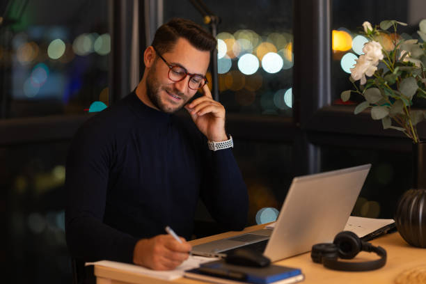istock Focused businessman working late at night in the office using laptop 2191300914