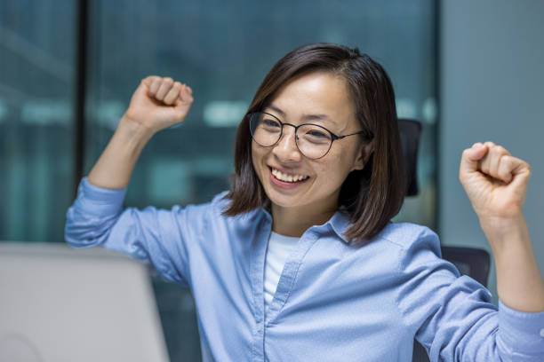 istock Asian businesswoman celebrating success while working on a project in office 2191302913