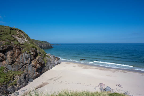 istock Serene coastal scene with soft sand, turquoise waters, dramatic cliffs, and a peaceful, scenic beach in Scotland, Durness Beach. 2191302960