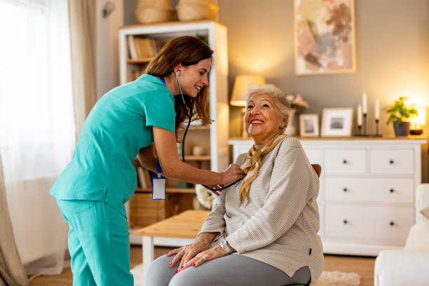istock Nurse Assisting an Elderly Woman During a Health Check in a Home Setting 2191305472