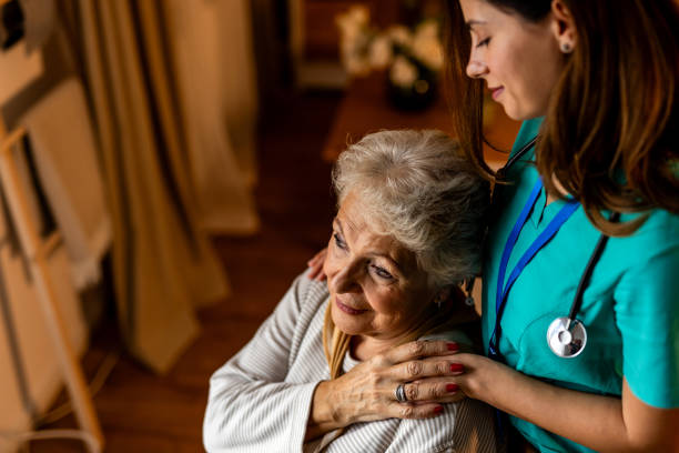 istock Caring Nurse Comforts Elderly Woman in a Warm and Compassionate Environment 2191305850