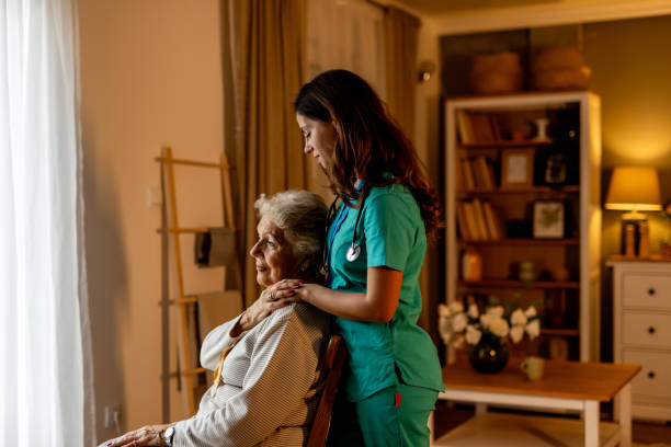 Caring Nurse Supporting Elderly Woman in Cozy Home Setting