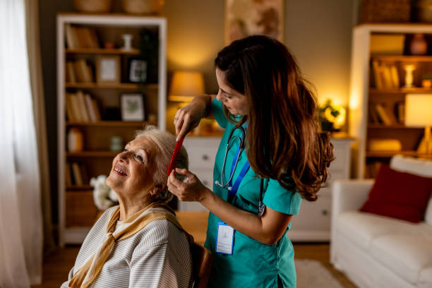 istock Caregiver Assisting Elderly Woman in a Comfortable Home Setting 2191305877