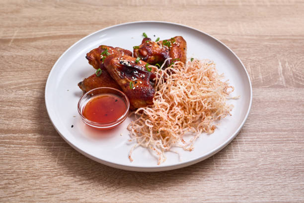 istock Spicy Glazed Chicken Wings with Crispy Noodles 2191306791