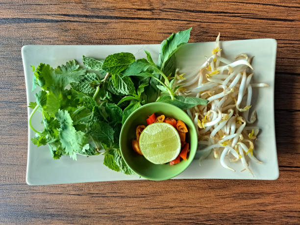 Ingredient For Pho Soup Is Bean Sprouts, Mint Leave, Coriander Leave, Asian Basil Leave, Sliced ​​Chili And Lime. Top View.