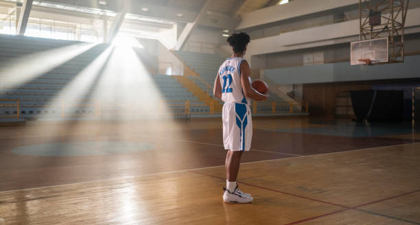 istock Basketball Player Standing With Ball At Court 2191309697