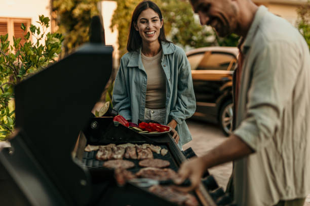 istock Loving couple enjoying BBQ day 2191310012