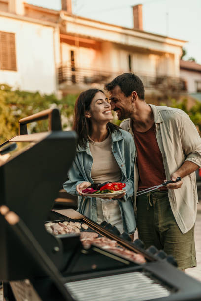 istock Loving couple enjoying BBQ day 2191310583