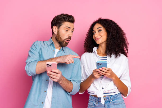 istock Young couple sharing excitement about mobile content together, vibrant colorful background 2191311364
