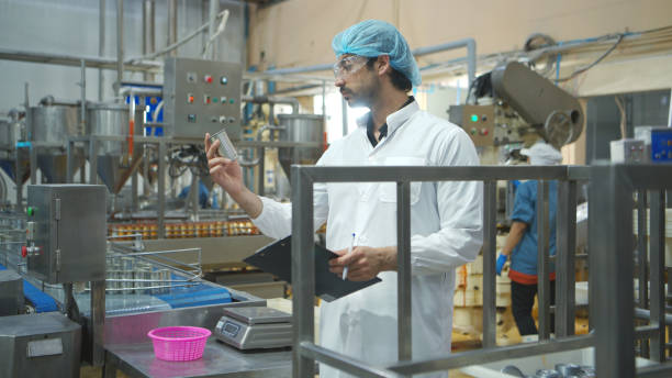istock Production control supervisor inspects and controls the operation of each step in the production line of a canned fish factory 2191311414