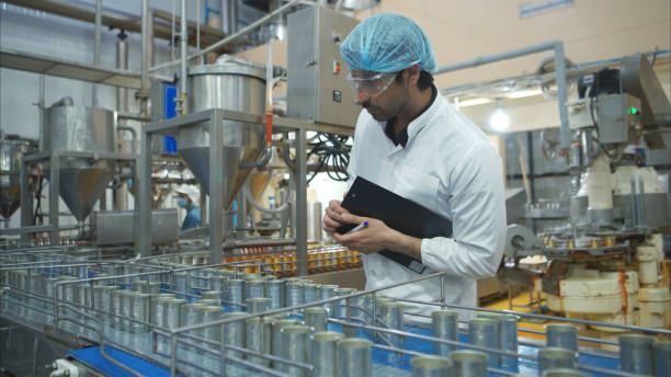 istock Production control supervisor inspects and controls the operation of each step in the production line of a canned fish factory 2191311491