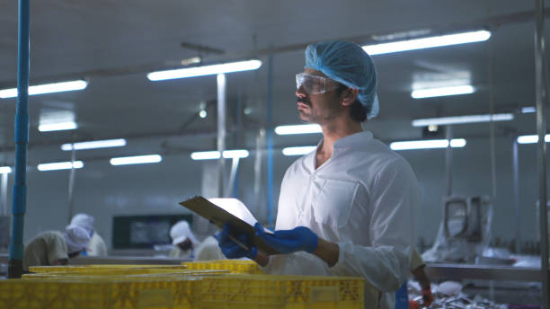 istock Production control supervisor inspects and controls the operation of each step in the production line of a canned fish factory 2191312135