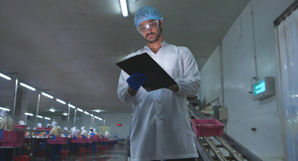 istock Production control supervisor inspects and controls the operation of each step in the production line of a canned fish factory 2191312207