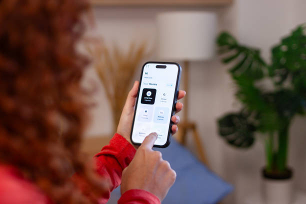 istock Woman using smart home application on mobile phone to control home appliances 2191314301