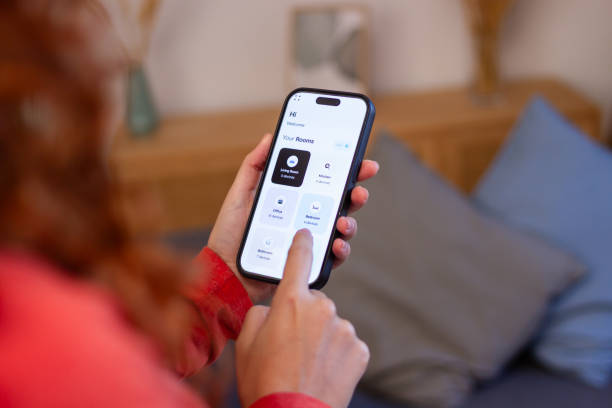 istock Woman using smart home app on mobile phone for home automation 2191314324