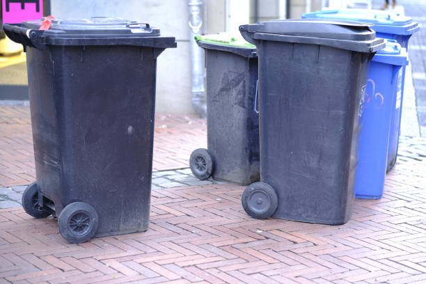 istock Garbage Cans or Dumpsters stand in a Row on the Street 2191314474