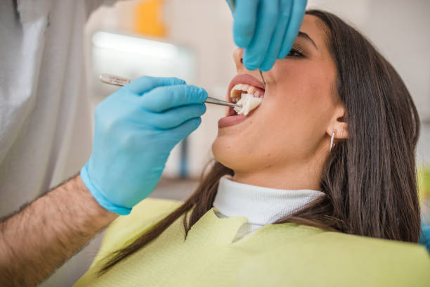 istock Male dentist extracts the patient's tooth 2191315247