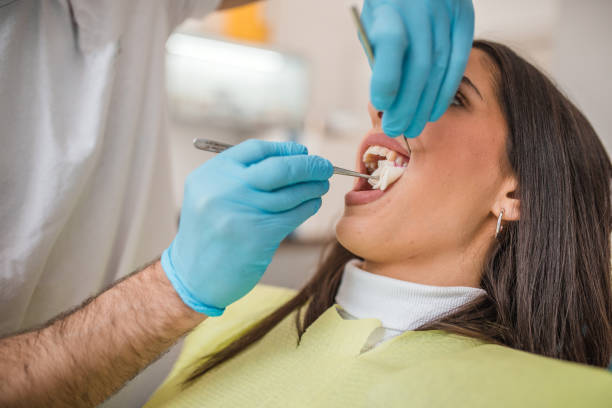 istock The dentist extracts the female patient's tooth 2191315690