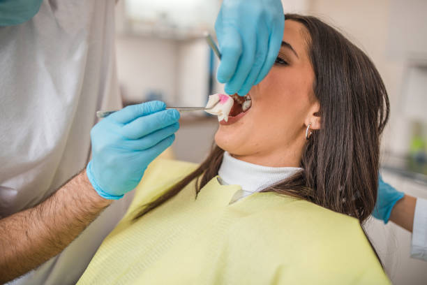 istock The dentist extracts the patient's tooth 2191315706