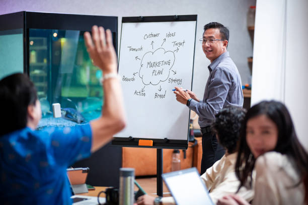 istock Mature Asian business man leads the session with a collaborative vision, encouraging teamwork and innovation 2191317831