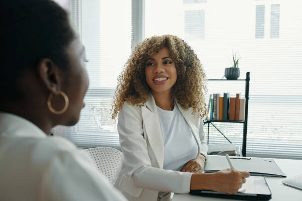 istock Smiling Businesswoman Engaging With Colleague in Office Setting 2191320125