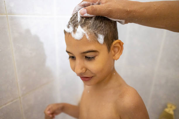 istock Mother Gently Washing Son's Hair 2191320289