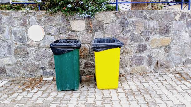 istock Large plastic trash cans in green and yellow. 2191320663